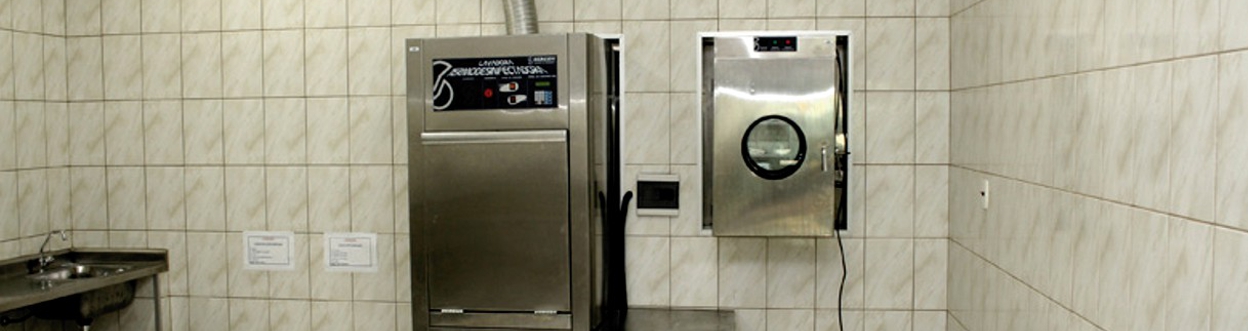 Two doctors smiling, one male doctor holding stethoscope, one female doctor holding clipboard, on light blue background with rounded corners